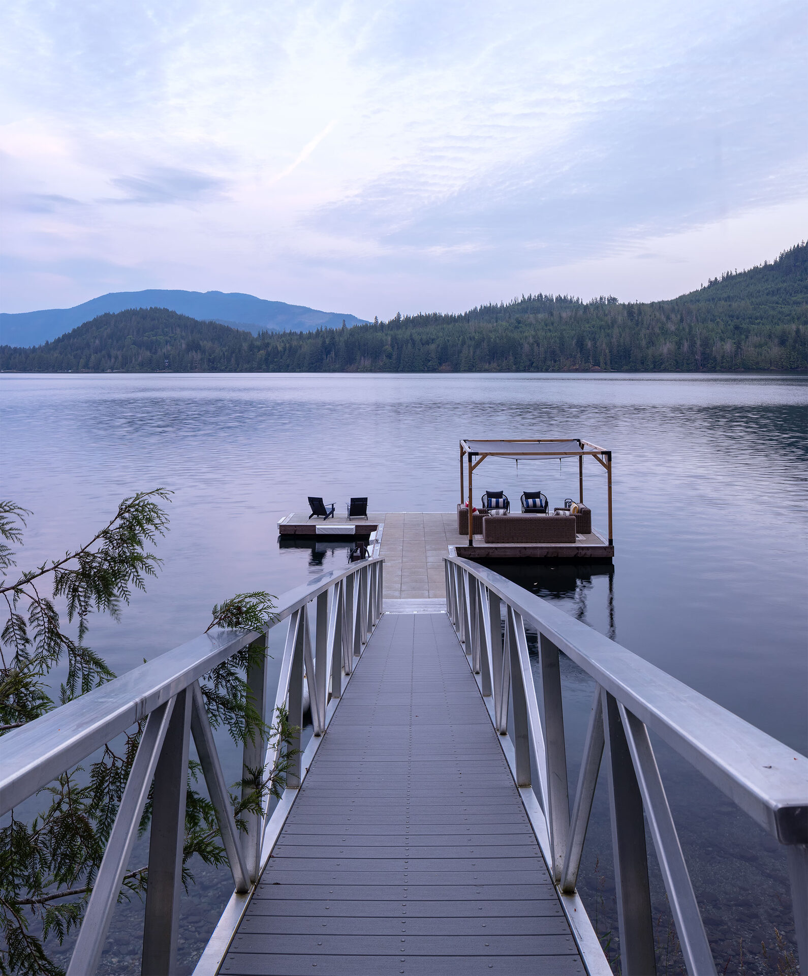 The private dock and pergola over still water at dusk, a natural ceremony backdrop