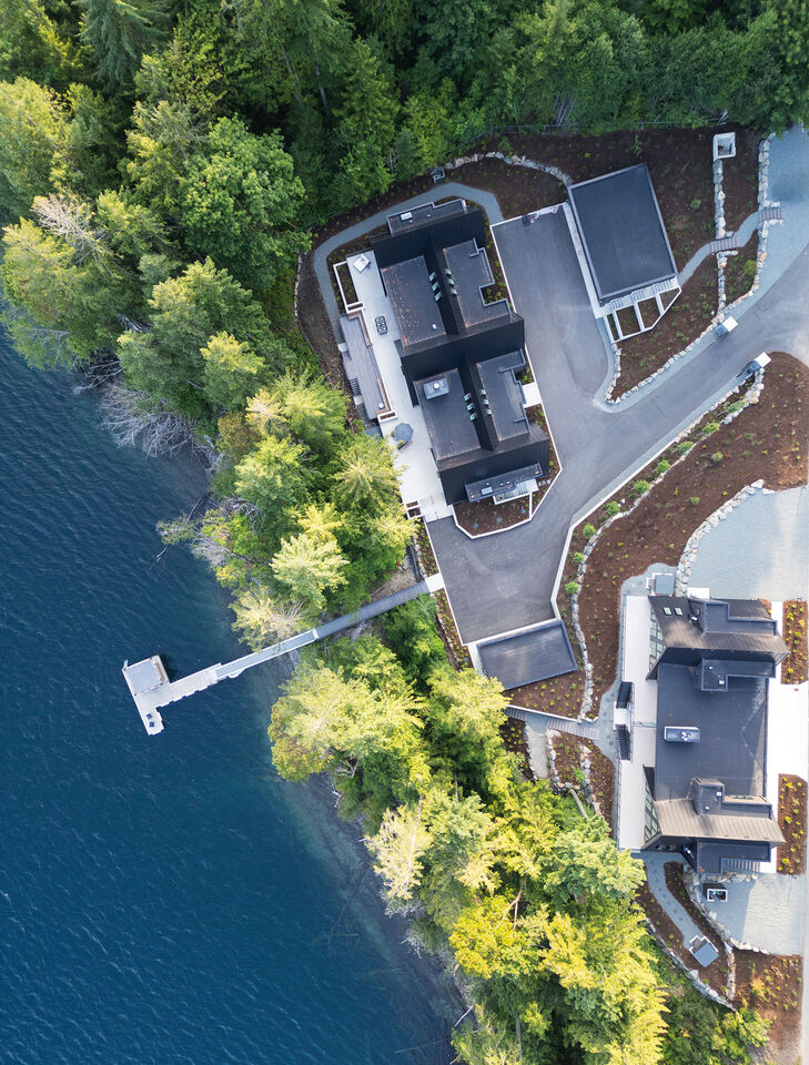 Top-down aerial of the cabins, shoreline and private dock