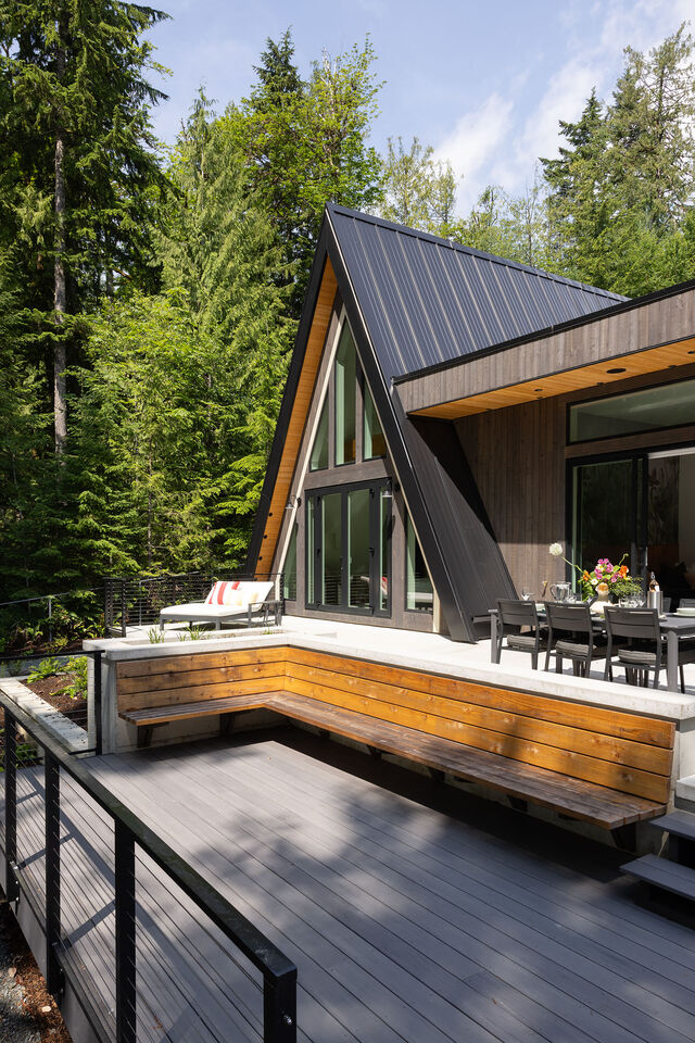 The A-frame and deck set for outdoor dining in daylight