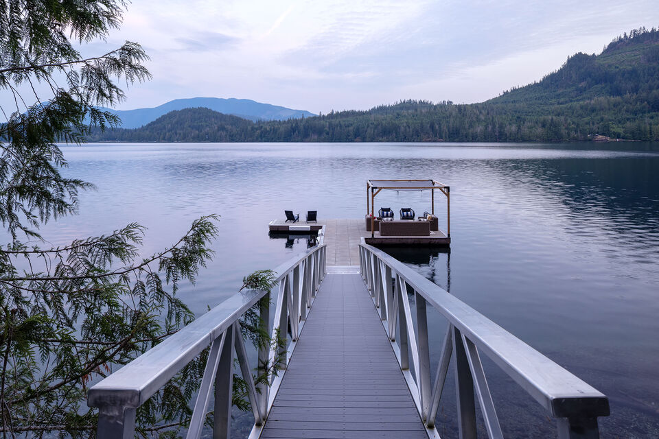 The private dock and pergola over still water at dusk