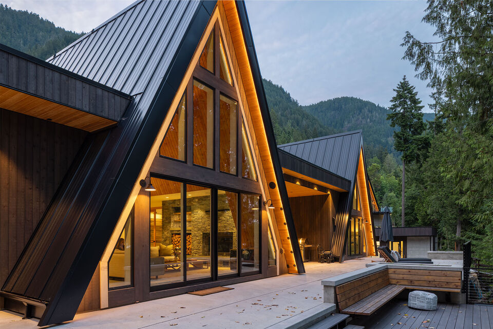 The A-frames glowing over the deck at blue hour