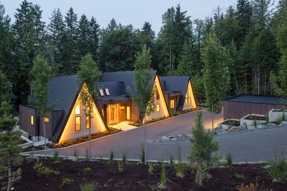 The cabins lit among the trees at dusk