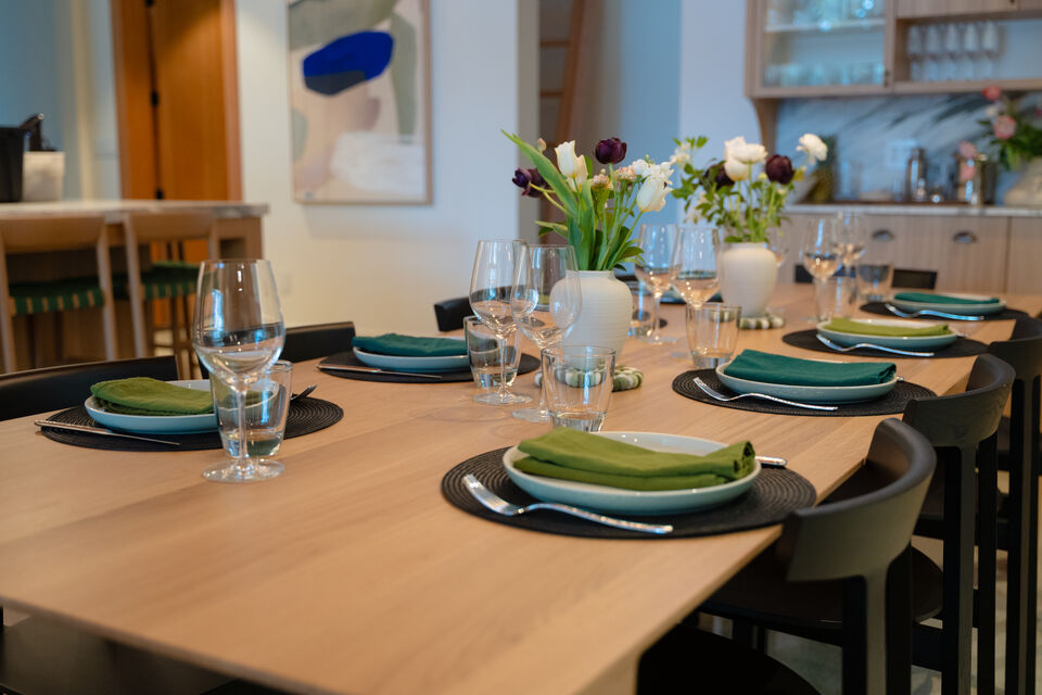 The long table dressed in green napkins and tulip centrepieces