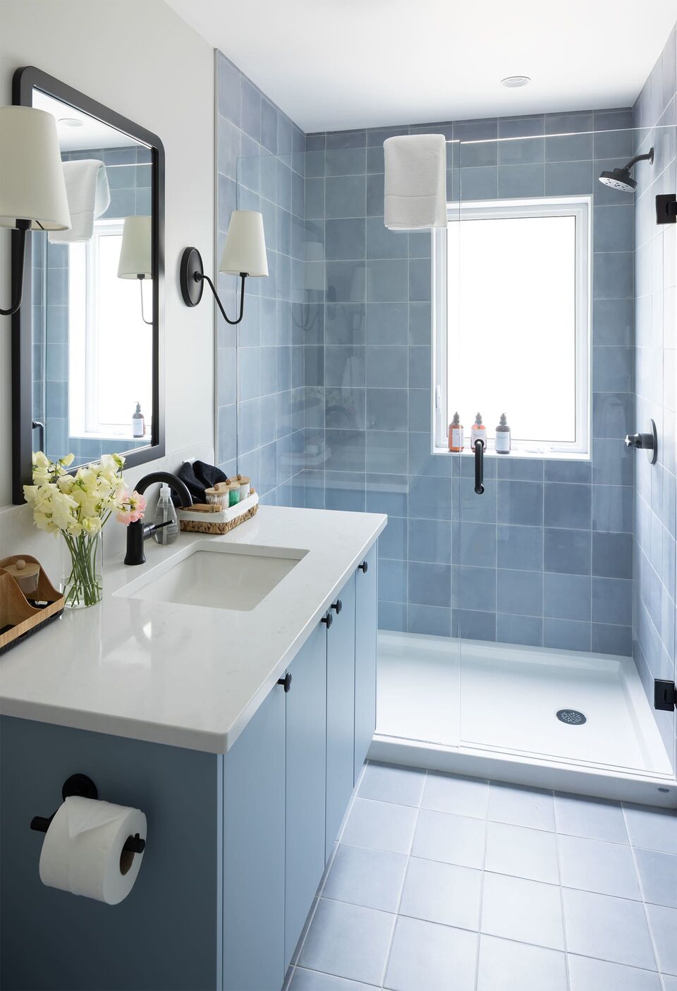 Cabin 1 bathroom with blue tile shower and white vanity