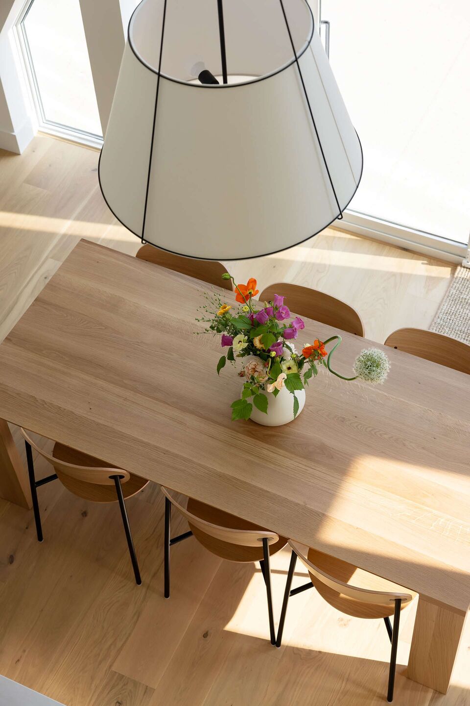 Dining table with fresh flowers under the skylight in Cabin 2