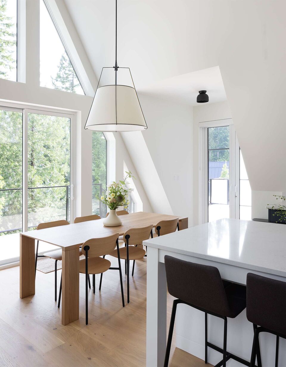 Cabin 1 dining nook and white kitchen island beneath the skylight