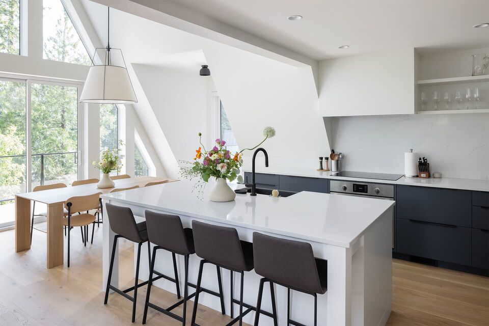 Cabin 1 white kitchen with island seating and black counter stools