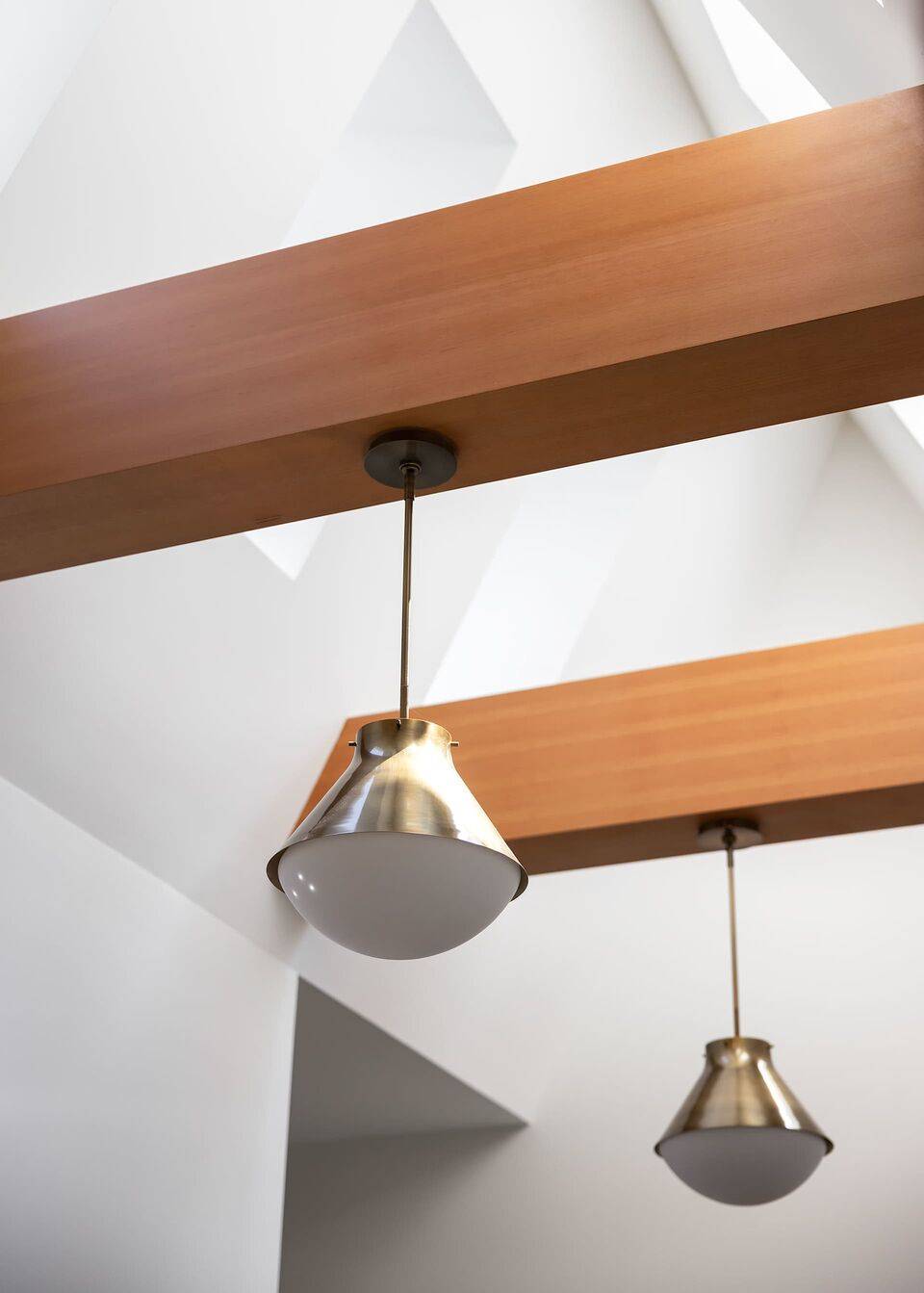 Pendant light and warm fir beam detail inside the Main Cabin