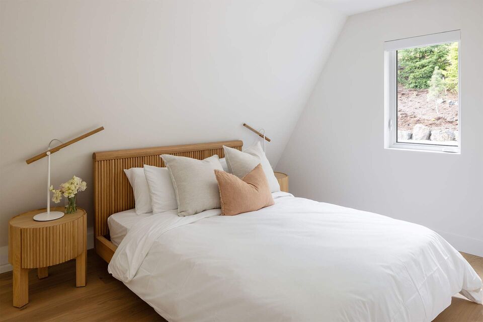 Cabin 2 bedroom with wood bed frame and crisp white duvet